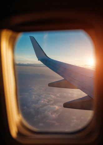 plane-window-view-clouds-islands-surrounded-by-sea-airplane-wing-traveling-1-.jpg